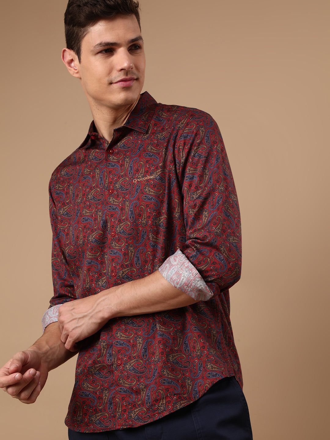 Man wearing a red red printed full sleeve 100% cotton shirt on a light gray background