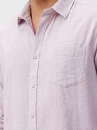 Man wearing a red rib textured cotton shirt light purple on a light gray background