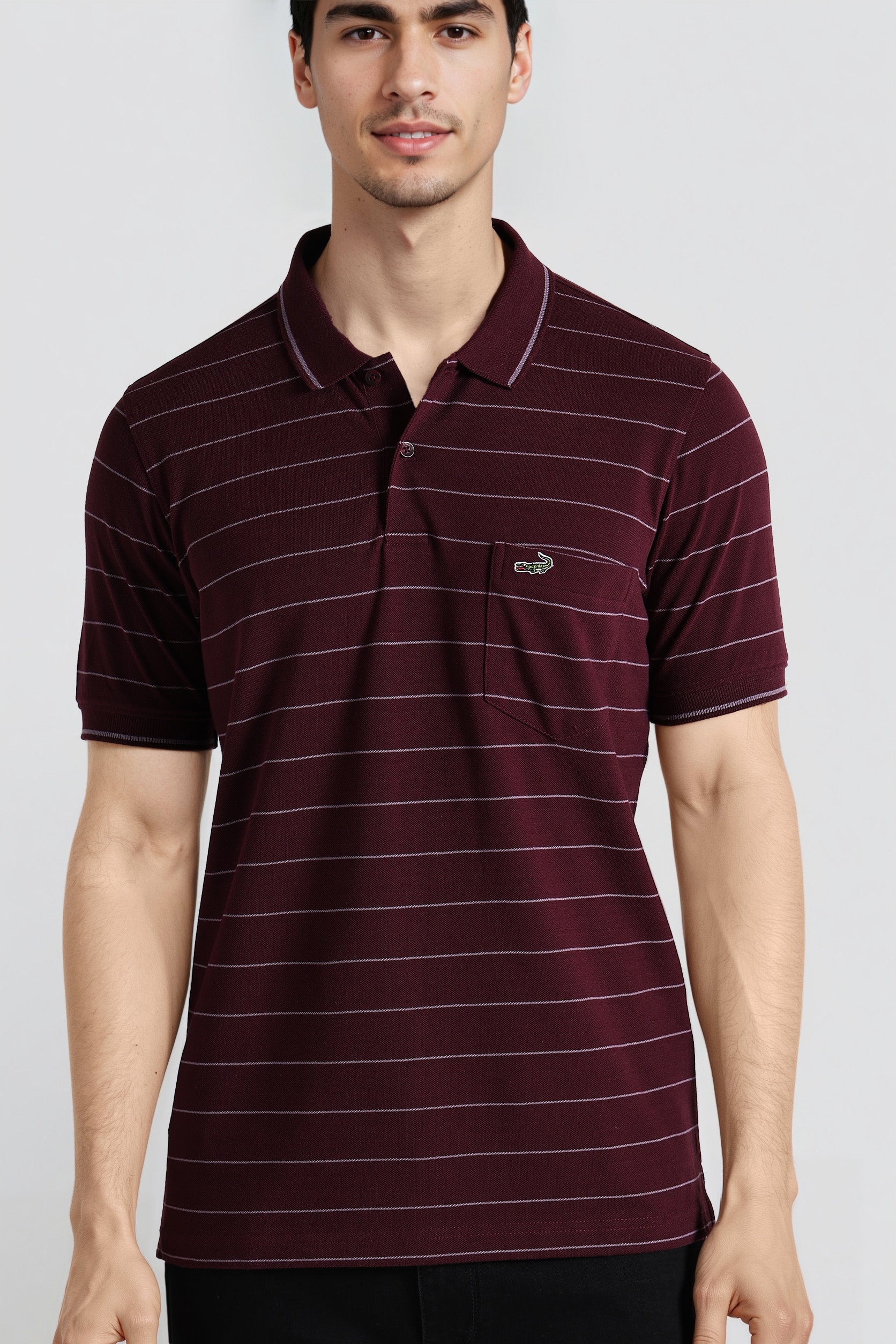 Man wearing a maroon striped polo shirt on a light gray background