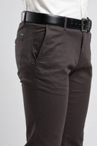 Brown pants with a black belt on a white background