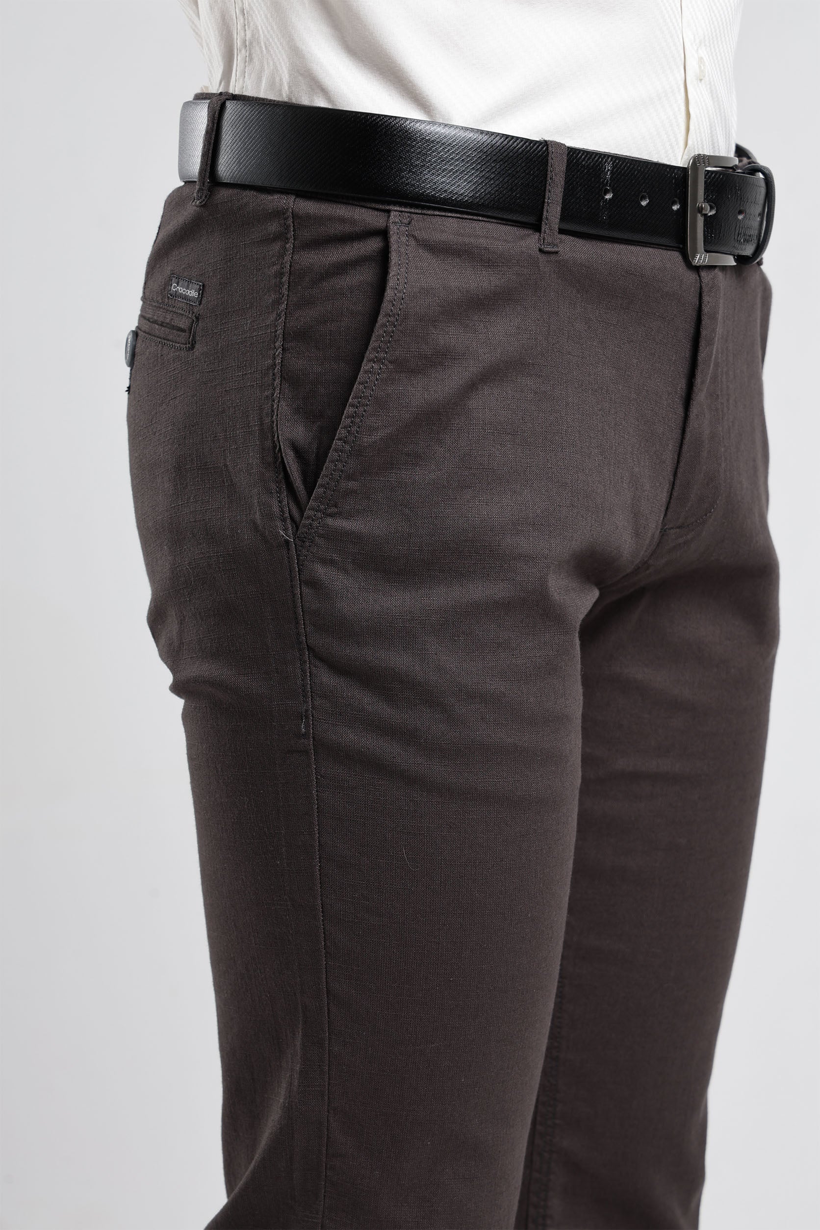 Brown pants with a black belt on a white background