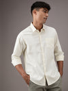 Man wearing a yellow light yellow solid full sleeve 100% cotton shirt on a light gray background