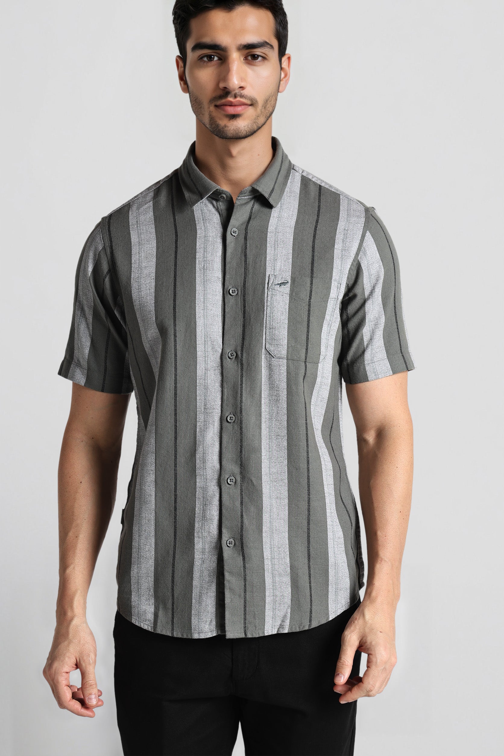 Man wearing a gray and black striped shirt on a white background