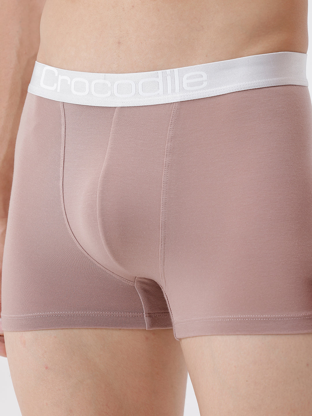 Person wearing boxer briefs with a visible brand logo on a plain background
