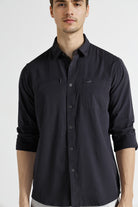 Man wearing a black button-up shirt on a white background