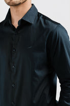 Black shirt worn by a person on a light gray background
