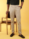 Man wearing a beige casual beige solid casual trouser on a light gray background