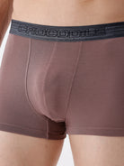 Brown boxer briefs with a black Crocodile brand waistband on a neutral background