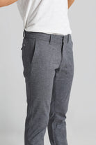 Gray pants worn by a person on a plain background