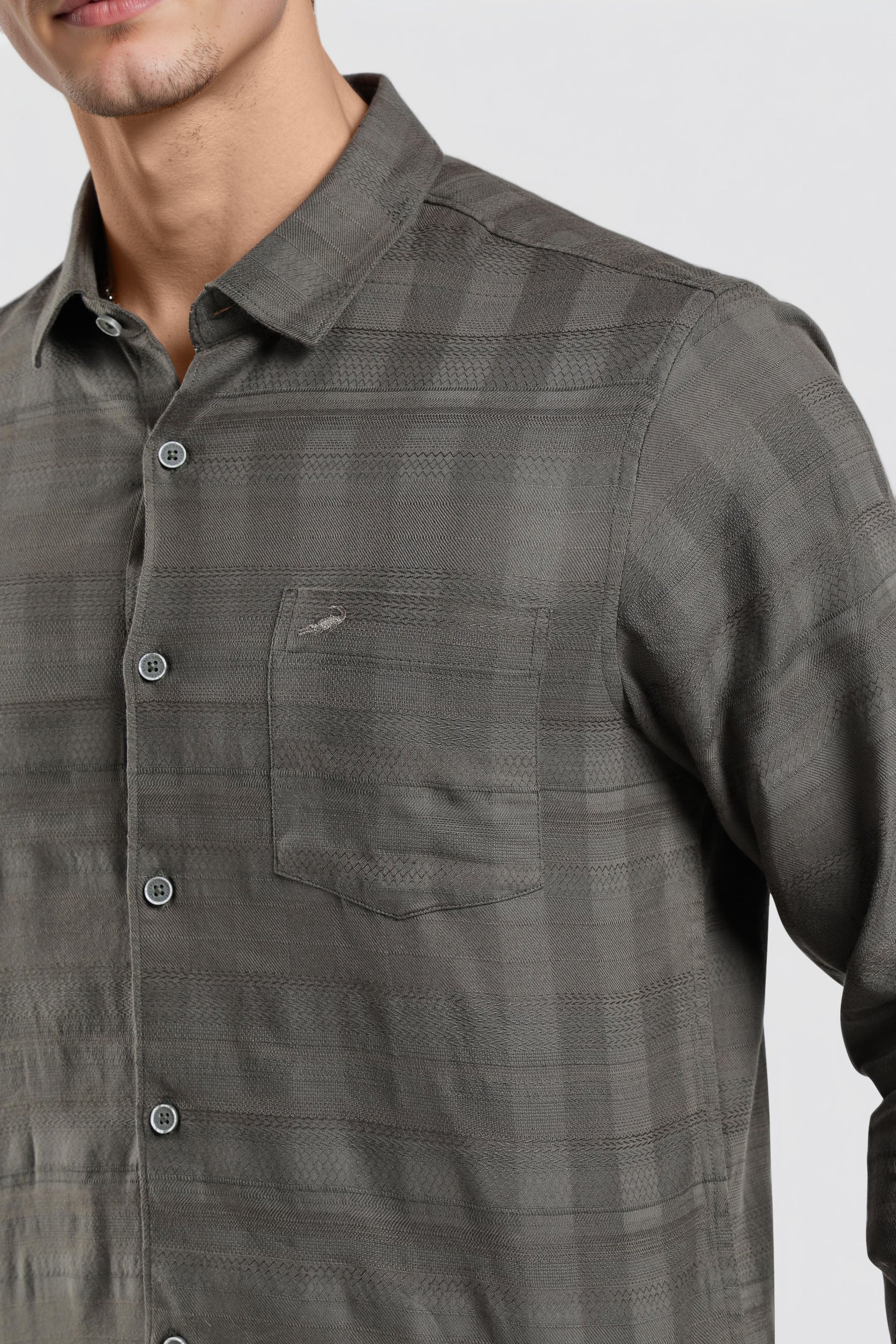 Gray checkered shirt worn by a person on a light gray background