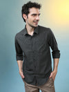 Man wearing a green cotton melange check shirt dark green with casual styling on a gray background