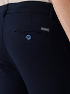 Man wearing a red textured essential chinos navy with casual styling on a gray background
