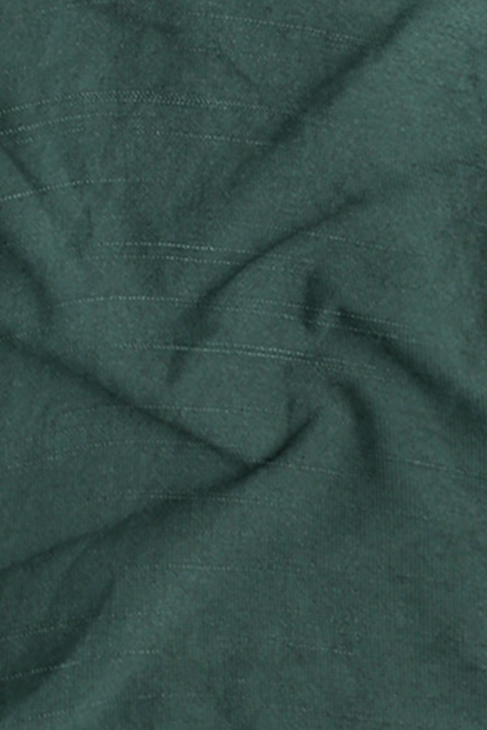 Close-up of green fabric with subtle texture