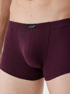 Maroon boxer briefs with a brand logo on a neutral background