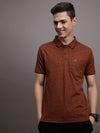 Man wearing a brown casual brown printed polo t shirt on a light gray background