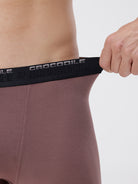 Person wearing a brown athletic outfit with a black waistband featuring 'Crocodile' branding.
