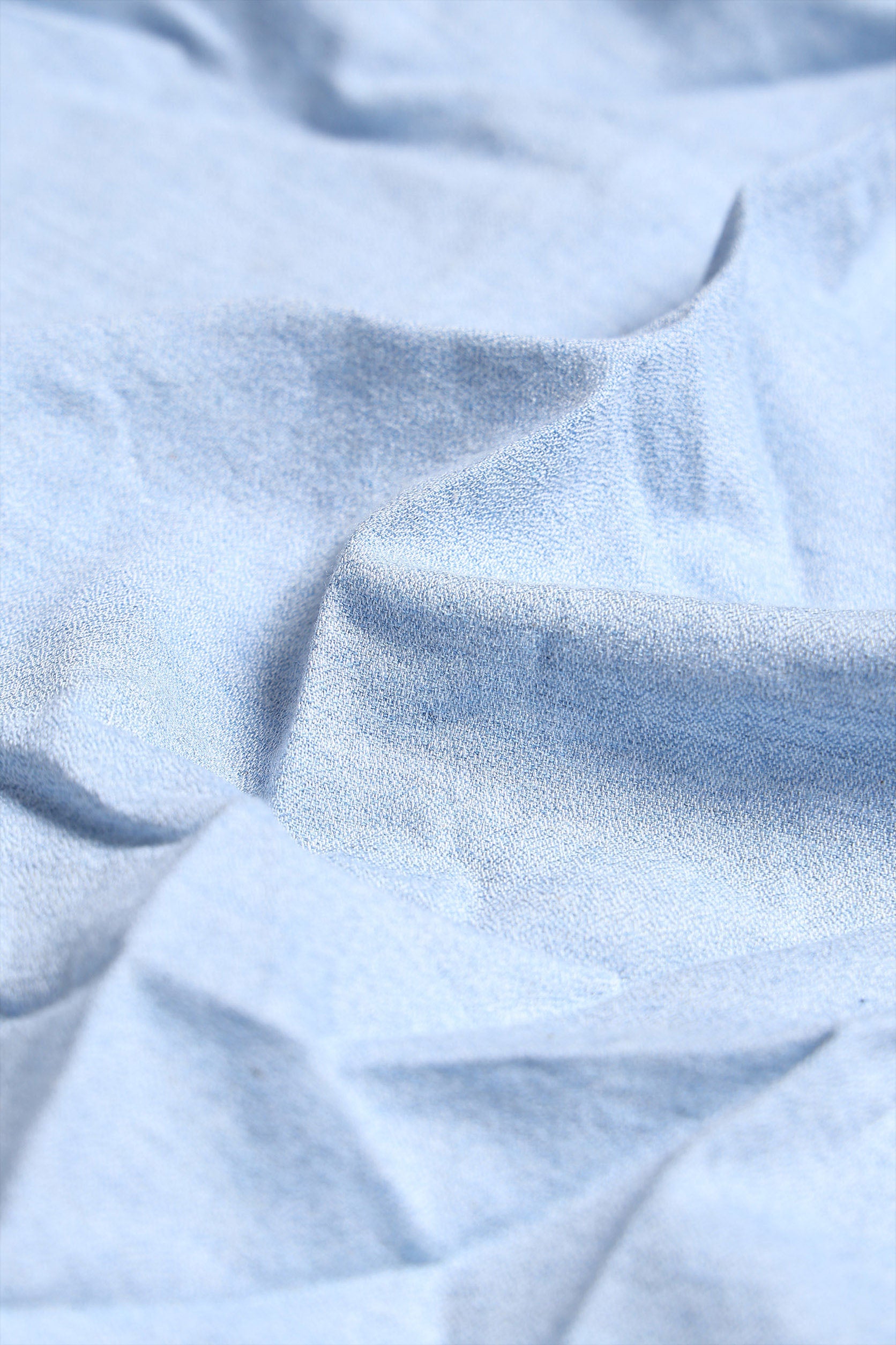 Close-up of light blue fabric with folds