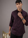 Man wearing a maroon printed casual full sleeve 100% cotton shirt with casual styling on a gray background