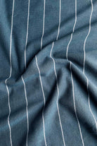 Close-up of blue fabric with white pinstripes