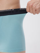 Person wearing a light blue athletic outfit with a black waistband featuring 'Crocodile' branding.