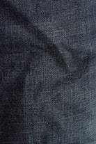 Close-up of dark blue denim fabric with a subtle pattern