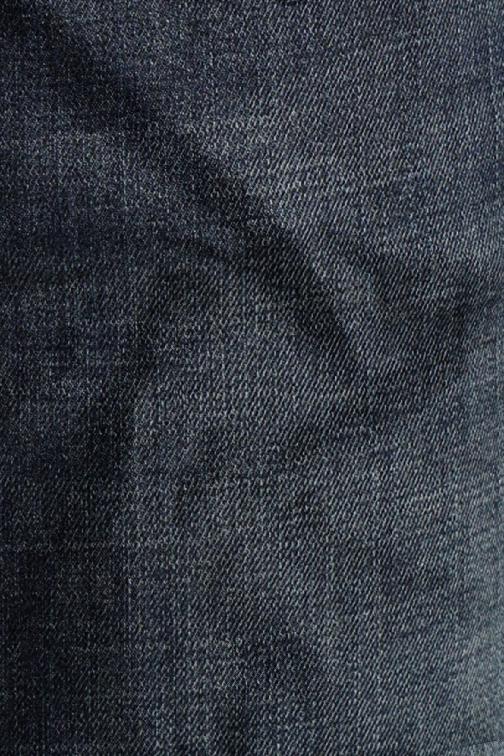 Close-up of dark blue denim fabric with a subtle pattern