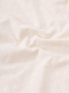 Man wearing a geomentic diamond print shirt on a light gray background