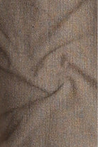 Close-up of textured brown fabric with a subtle pattern