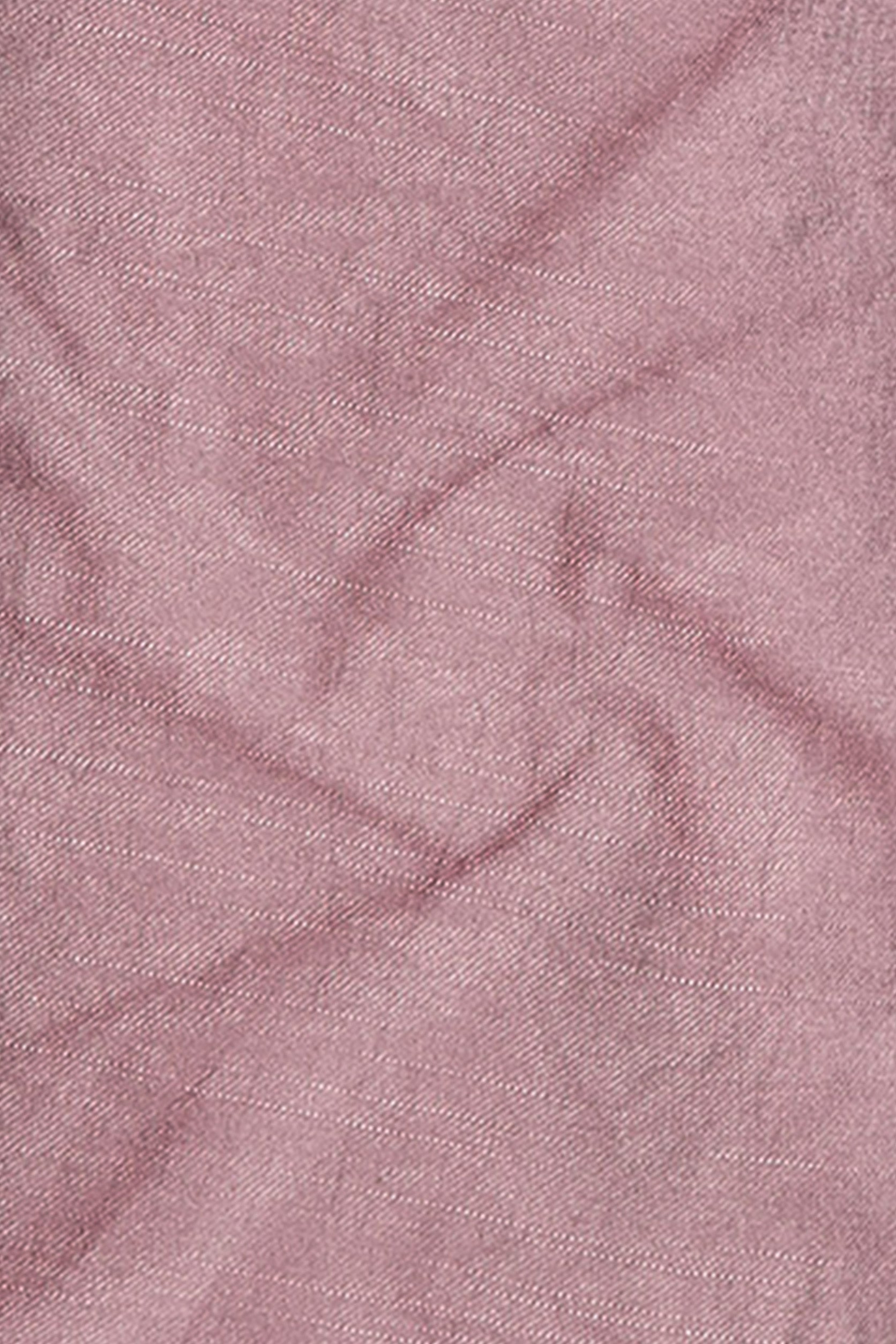 Close-up of pink fabric with a textured pattern
