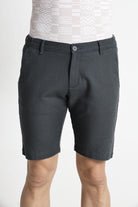 Person wearing dark gray shorts on a white background