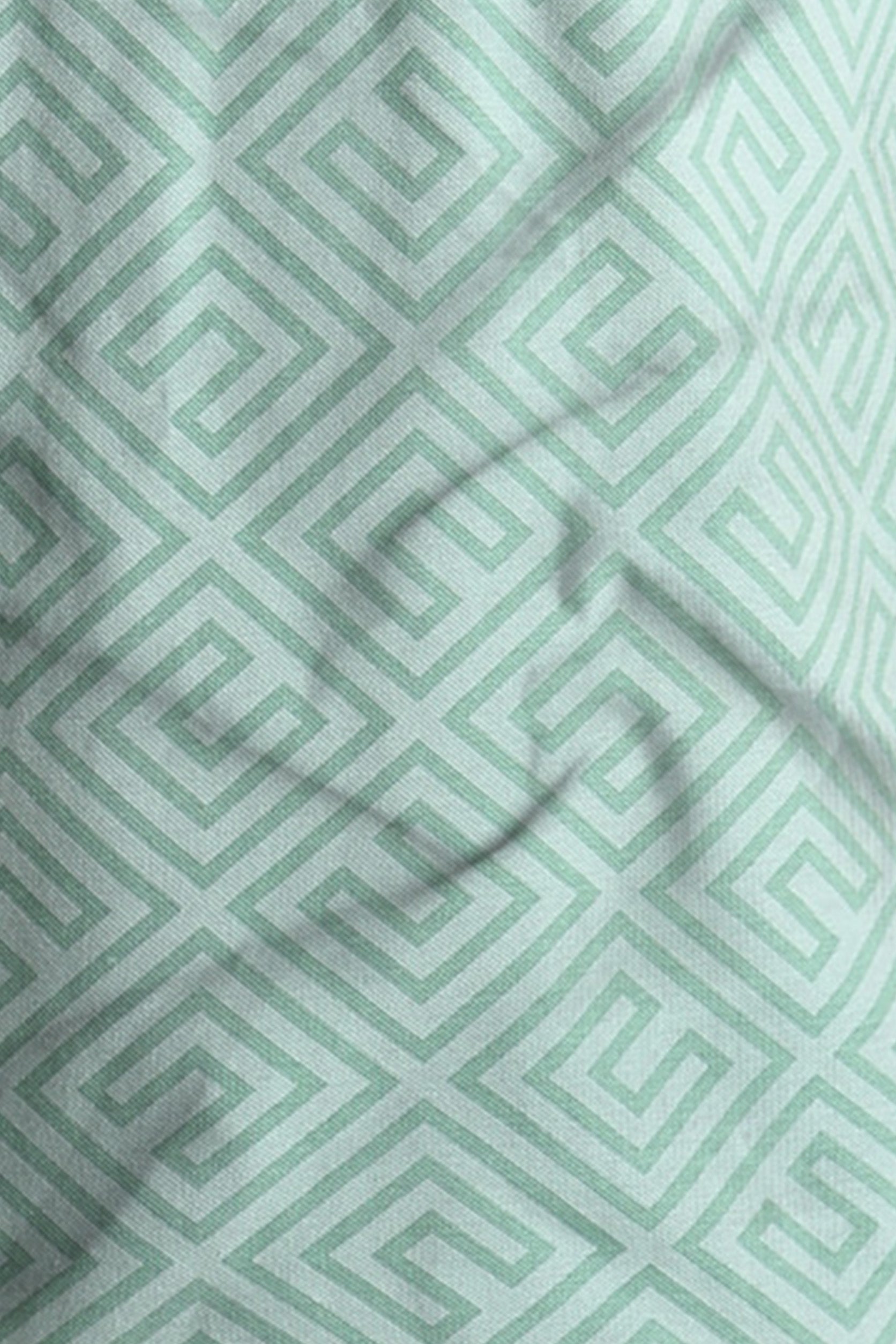 Close-up of a fabric with a green geometric pattern