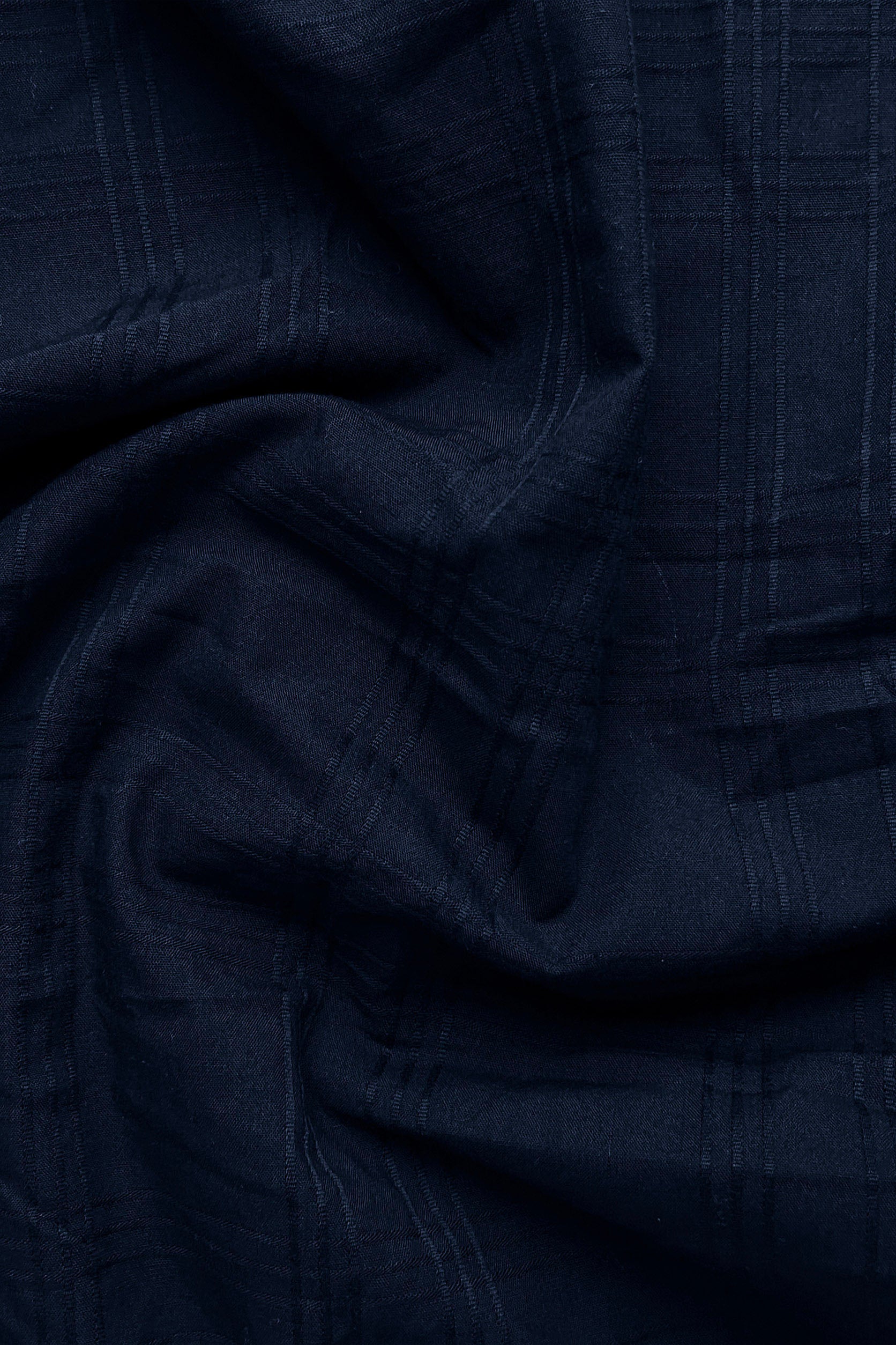 Close-up of dark blue fabric with a textured pattern