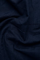 Close-up of dark blue fabric with a textured pattern
