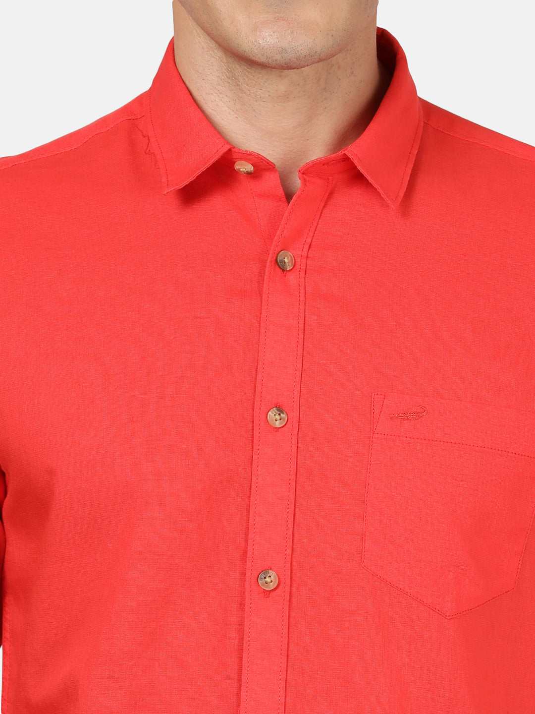 Man wearing a red red solid full sleeve linen shirt with casual styling on a gray background
