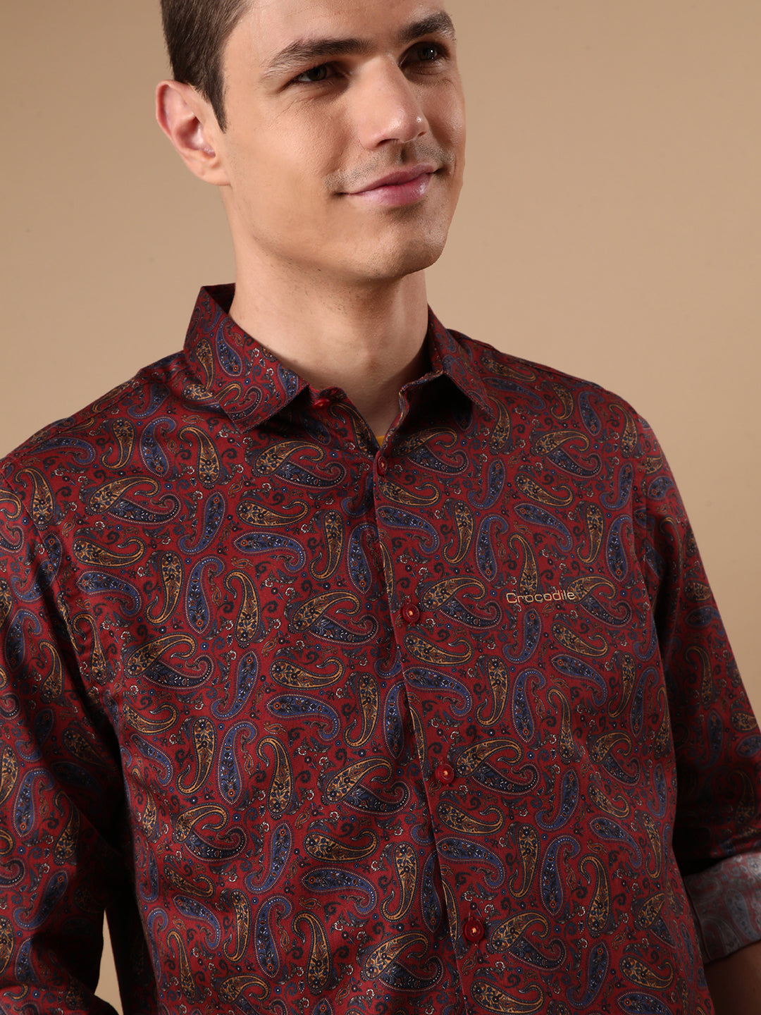 Man wearing a red red printed full sleeve 100% cotton shirt on a light gray background