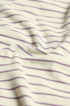 Close-up of fabric with purple stripes on a white background