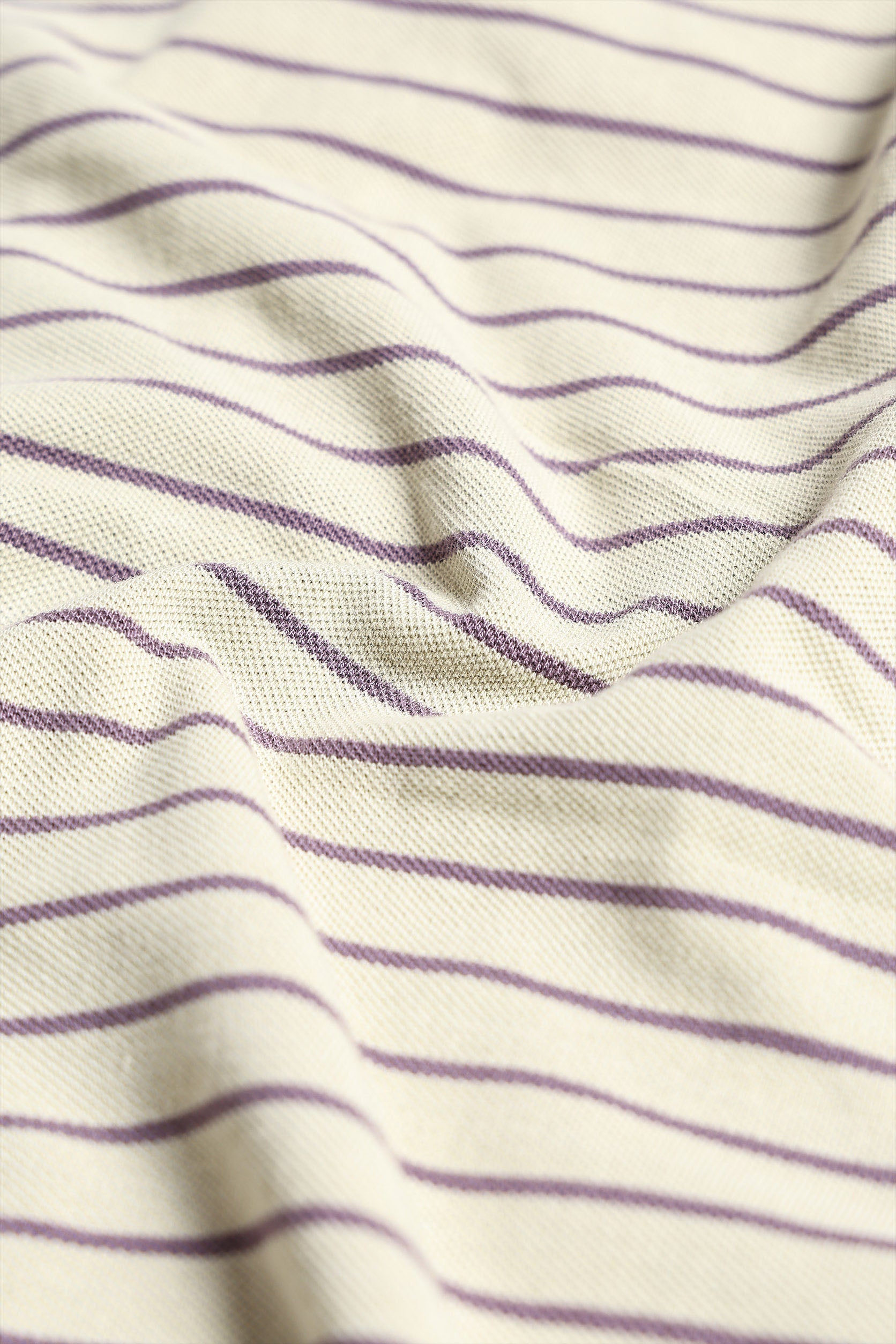 Close-up of fabric with purple stripes on a white background