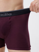 Maroon boxer briefs with a visible brand logo on a plain background