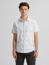 Man wearing a blue blue self checked shirt on a light gray background