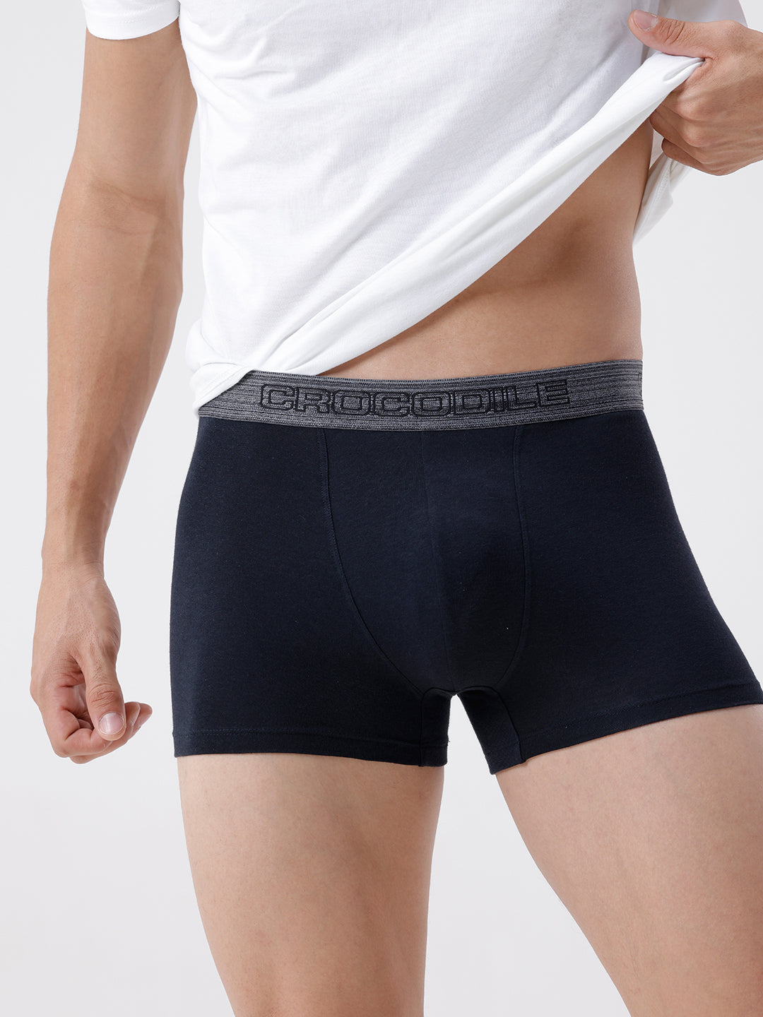 Person wearing black boxer briefs with a brand logo on a white background