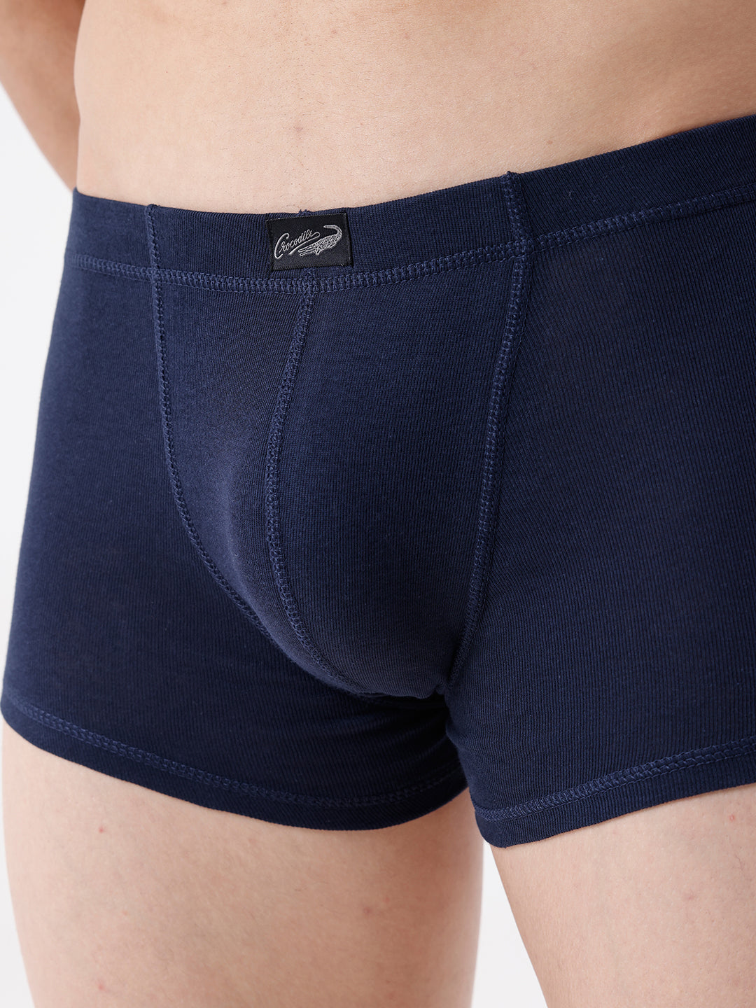 Navy blue boxer briefs with a brand label on a neutral background