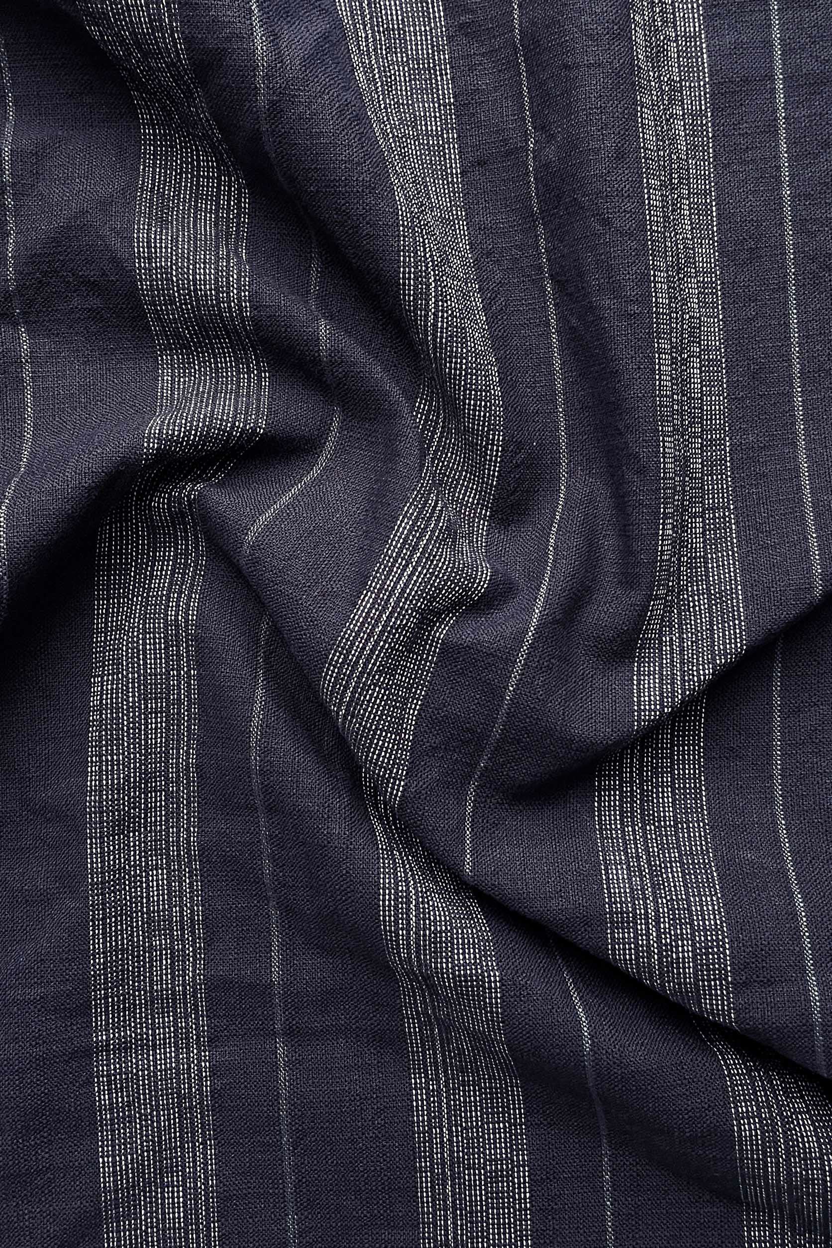 Close-up of dark blue fabric with subtle pattern