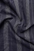 Close-up of dark blue fabric with subtle pattern
