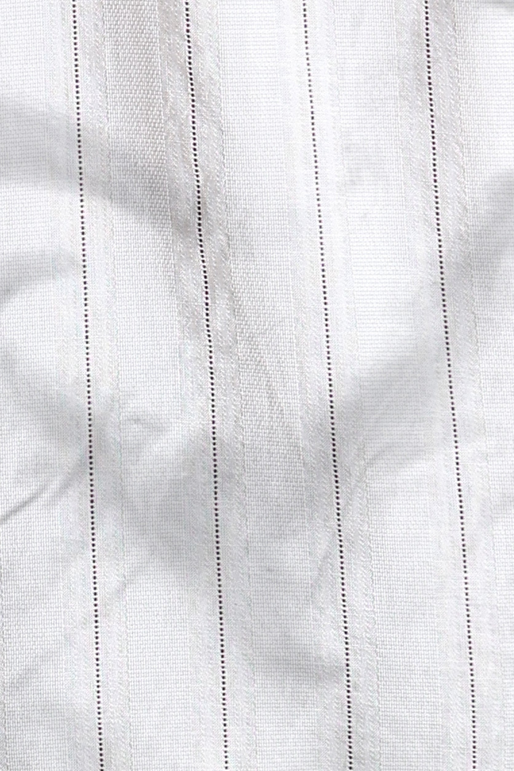 Close-up of white fabric with subtle texture and stitching details