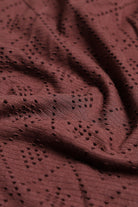 Close-up of a brown fabric with a subtle pattern