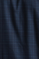 Close-up of dark blue fabric with a subtle check pattern