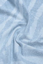 Close-up of light blue fabric with a subtle pattern
