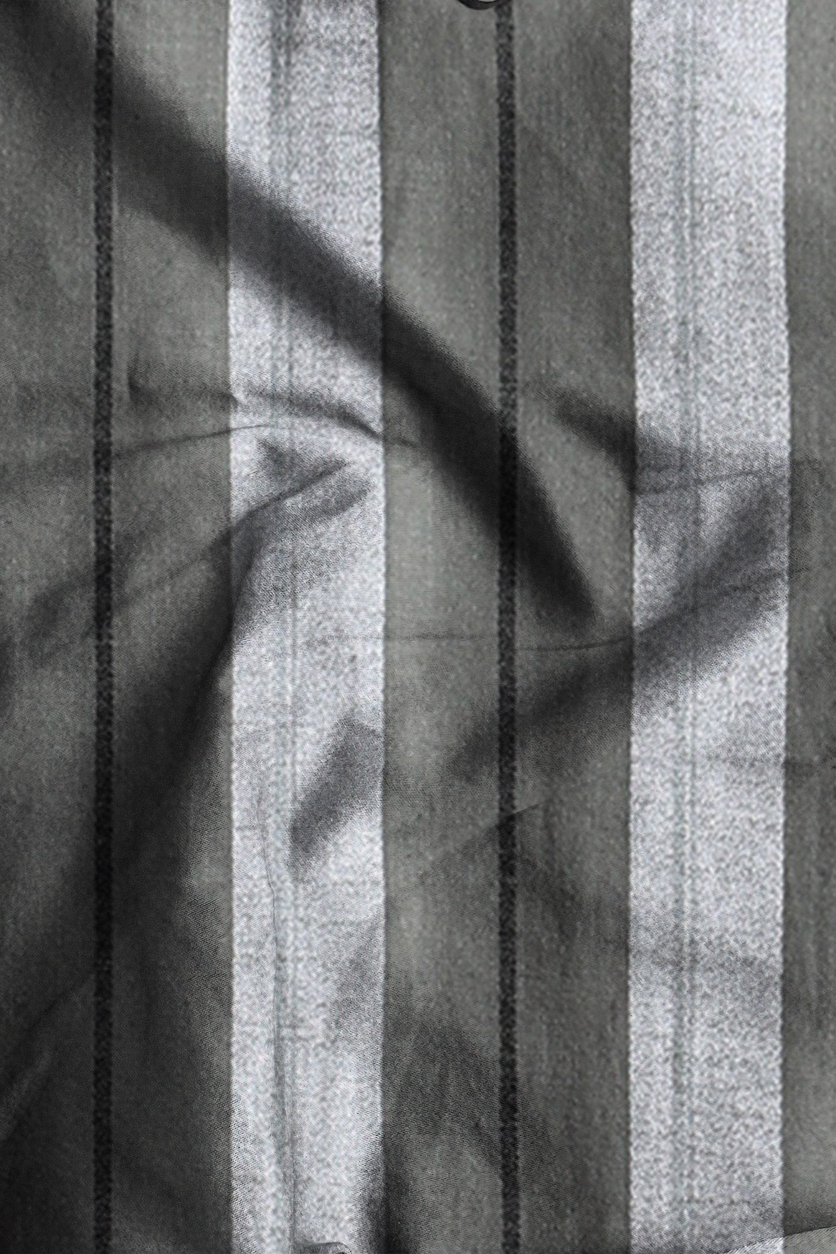 Black and white striped fabric with leaf shadows