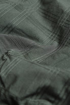 Close-up of green fabric with visible texture and stitching