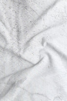 Close-up of textured white fabric with folds